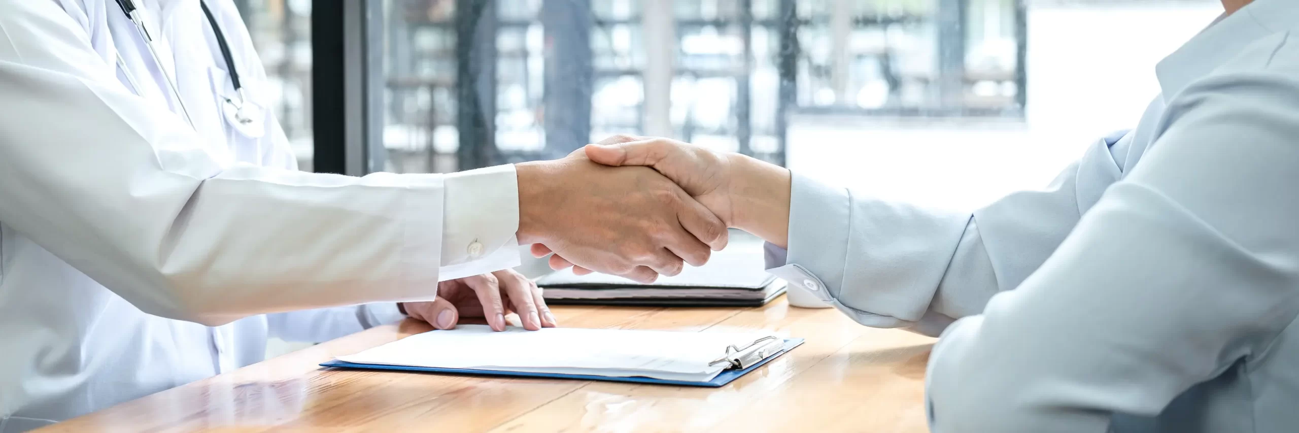 Doctor shaking hands with a businessman